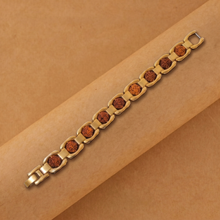 Premium gold-plated rudraksha link bracelet laid diagonally on a tan paper backdrop